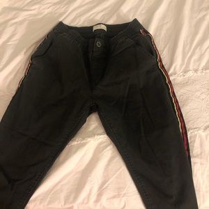 Grey pants red and yellow detailing on the sides